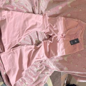 Soft pink sweatpants flare bottom. Never worn. Still has tag and bag.